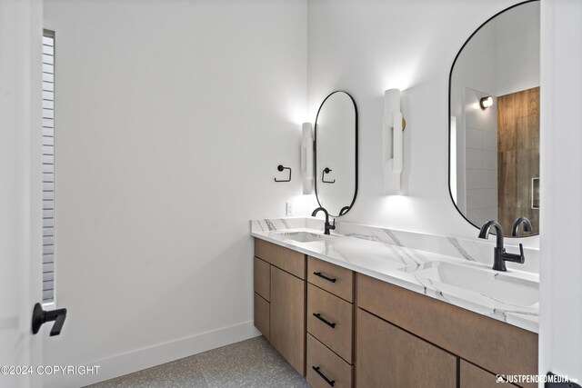 5376 Sandhill Loop, Anchorage, AK 99502 - bathroom featuring baseboards, a sink, and double vanity