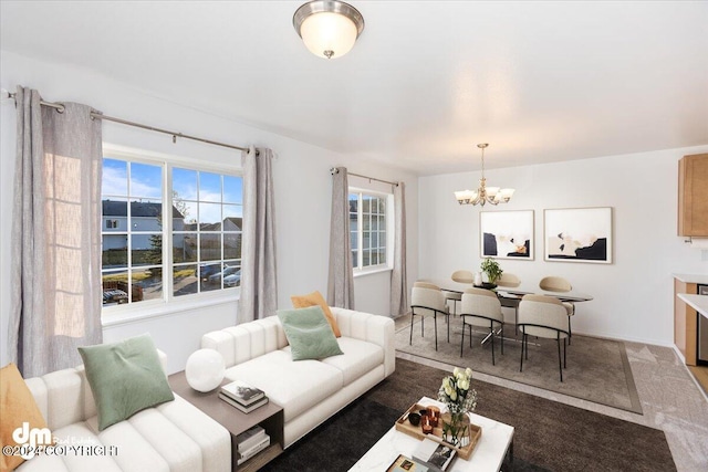 living room featuring a water view, carpet floors, and a chandelier