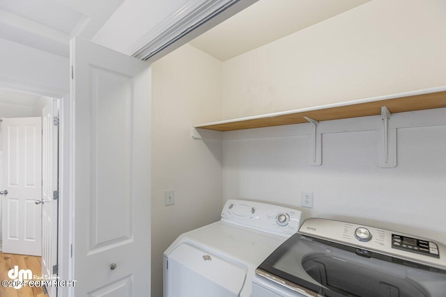 laundry area with washer and dryer and hardwood / wood-style floors