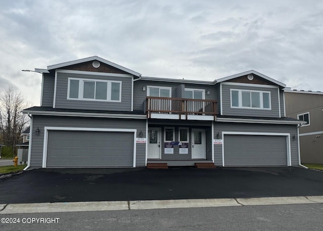 view of property with a balcony and a garage