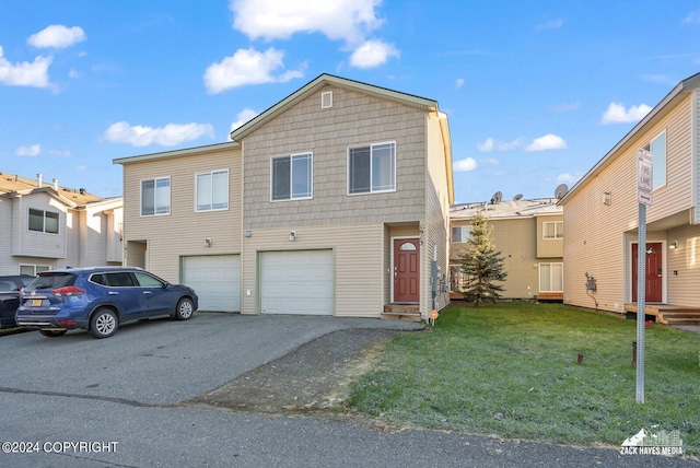 view of front of home with a front lawn and a garage