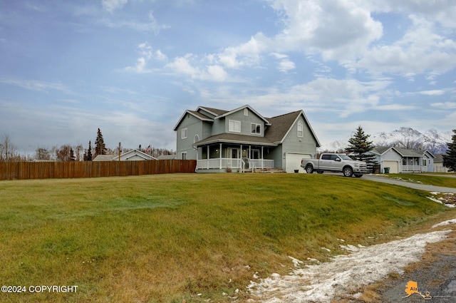 view of front of home with a garage, a sunroom, and a front yard