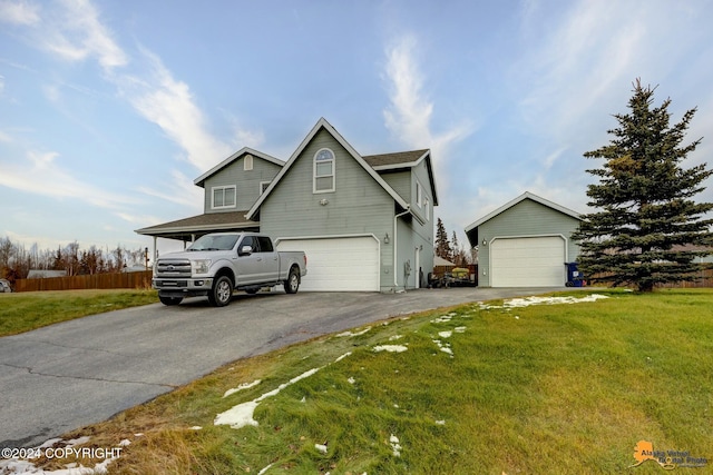 view of front of property featuring a front lawn and a garage