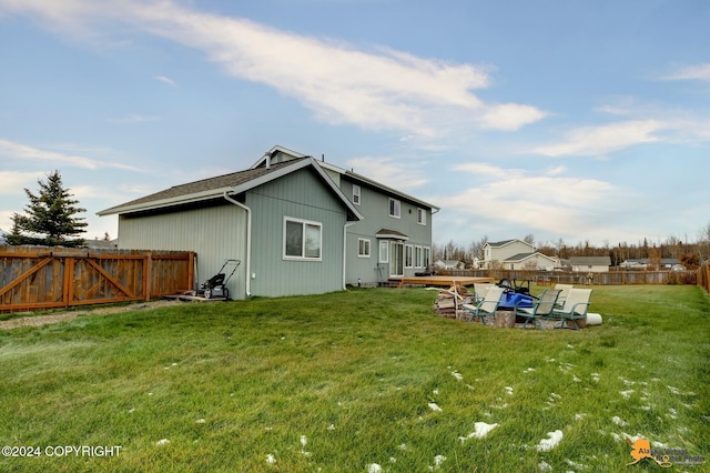 back of house featuring a yard