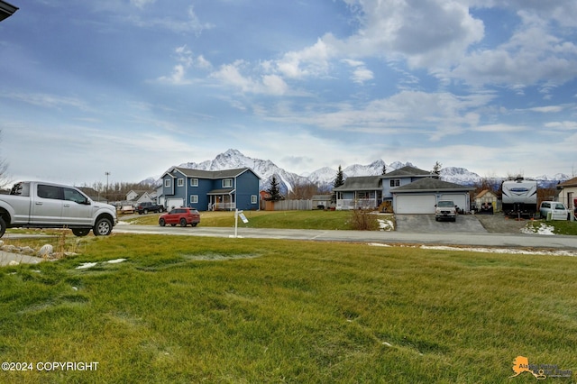 view of yard featuring a garage and a mountain view