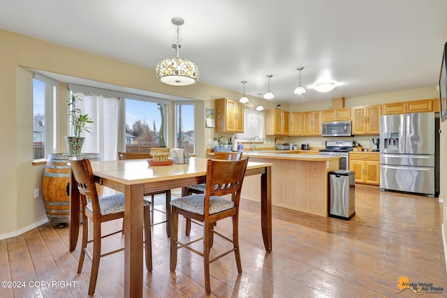 dining space featuring light hardwood / wood-style floors and sink