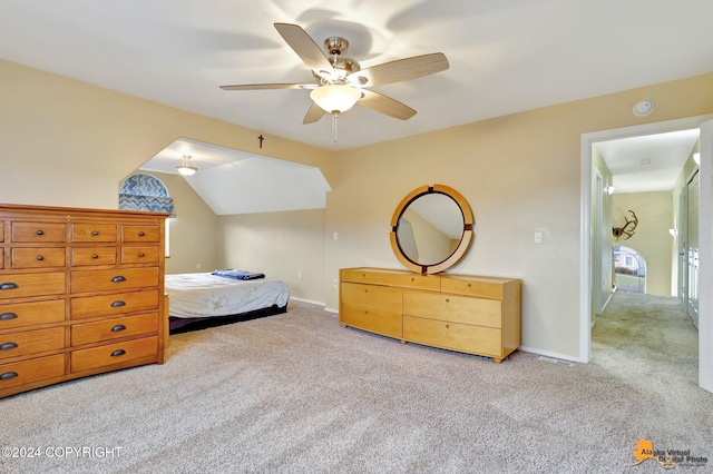 carpeted bedroom with ceiling fan and vaulted ceiling