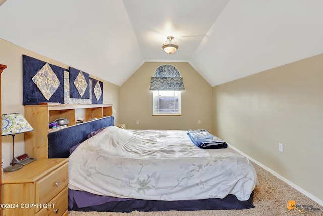 carpeted bedroom with lofted ceiling