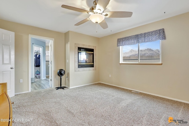 spare room featuring light colored carpet and ceiling fan