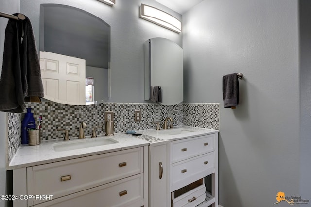 bathroom with tasteful backsplash and vanity