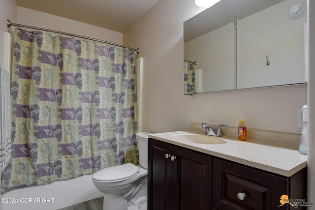 full bathroom with hardwood / wood-style flooring, vanity, shower / bathtub combination with curtain, and toilet