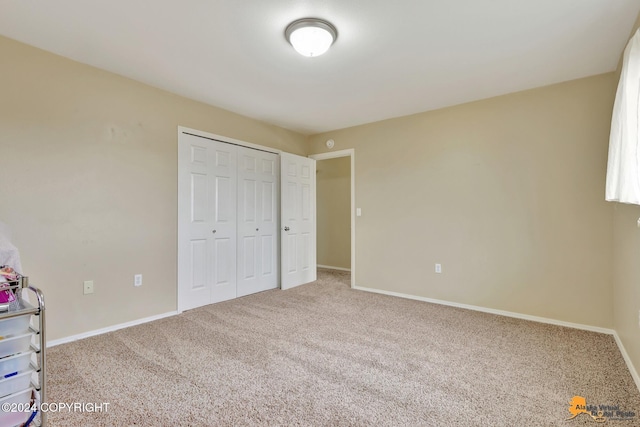 unfurnished bedroom featuring a closet and carpet floors