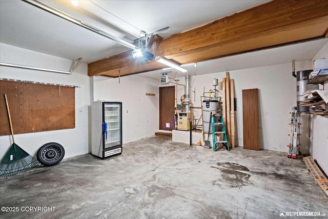 garage featuring a garage door opener and strapped water heater