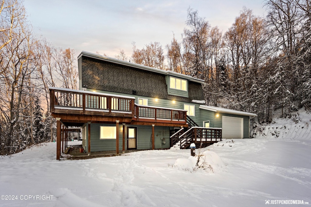 view of front of house with a garage and a deck