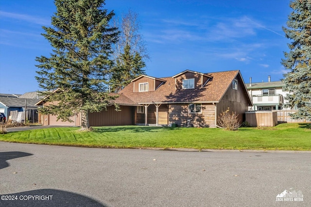 view of front of property with a garage and a front yard