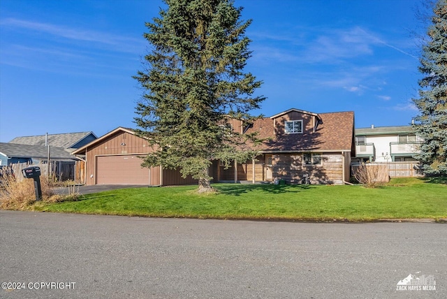 view of front of house featuring a garage and a front lawn