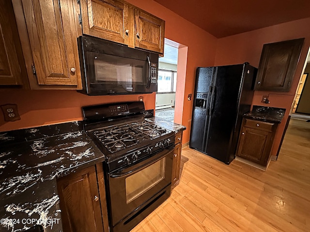 8111 Northview Dr, Anchorage, AK 99504 - kitchen featuring black appliances, light wood-style flooring, and dark countertops