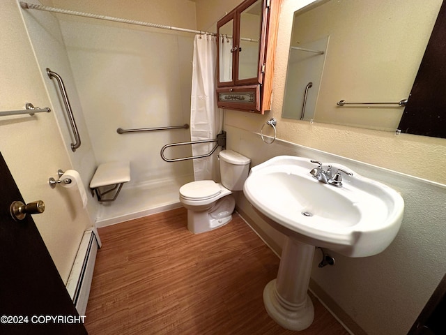 bathroom with baseboard heating, sink, wood-type flooring, toilet, and curtained shower