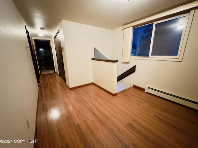 8111 Northview Dr, Anchorage, AK 99504 - unfurnished room featuring light wood finished floors, baseboards, and a baseboard heating unit