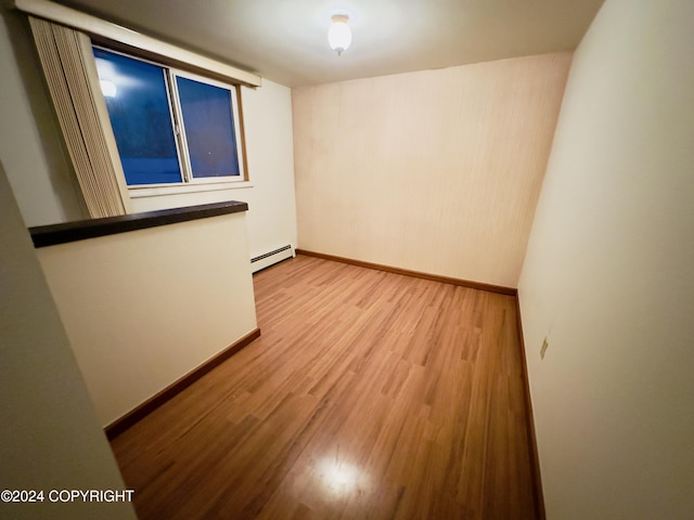 8111 Northview Dr, Anchorage, AK 99504 - empty room with light wood-style flooring, baseboard heating, and baseboards