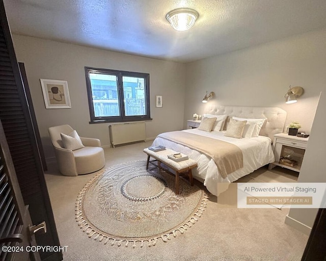 bedroom with carpet, radiator heating unit, and a textured ceiling