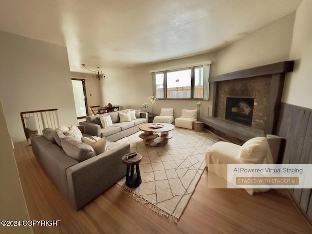 living room featuring light wood-type flooring and an inviting chandelier