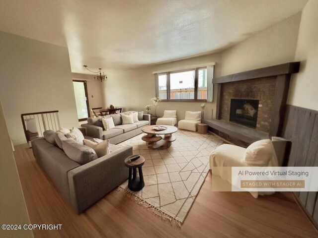 8111 Northview Dr, Anchorage, AK 99504 - living room featuring healthy amount of natural light, wood finished floors, a chandelier, and a fireplace with raised hearth