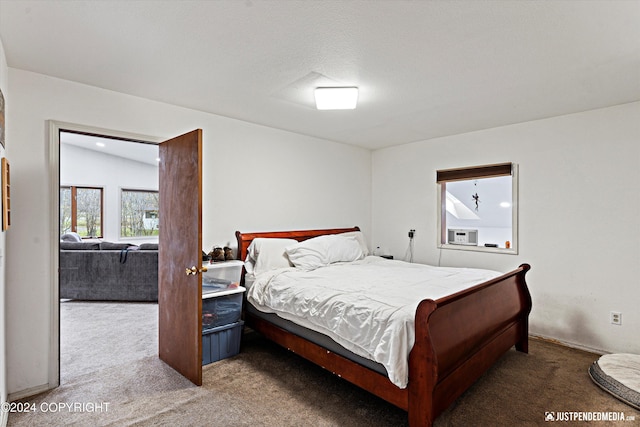 carpeted bedroom featuring lofted ceiling and a textured ceiling