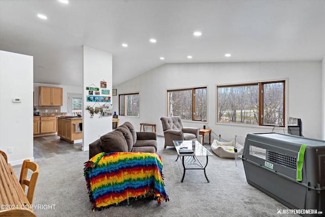 carpeted living room with heating unit and vaulted ceiling