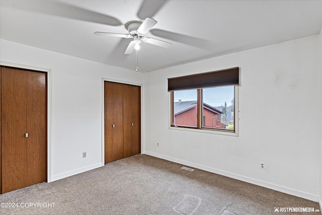 unfurnished bedroom featuring carpet and ceiling fan