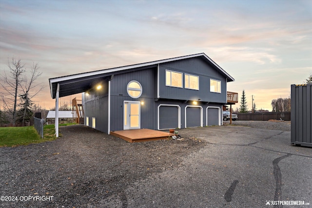 view of front facade featuring a deck and a garage