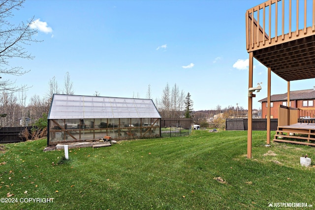 view of yard with a wooden deck and an outbuilding