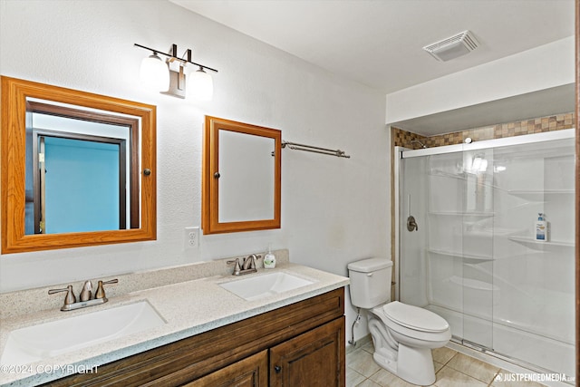 bathroom featuring vanity, toilet, an enclosed shower, and tile patterned floors