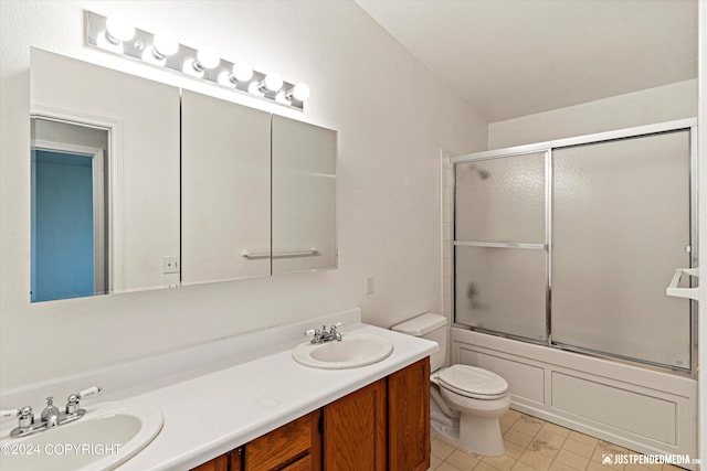 full bathroom with vanity, toilet, and combined bath / shower with glass door