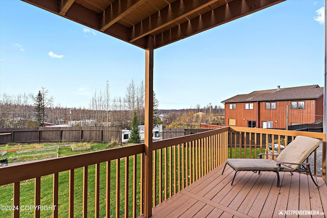 wooden terrace featuring a yard