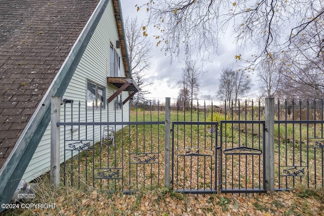 4480 E 138th Ave, Anchorage, AK 99516 - view of side of property featuring a shingled roof and a gate