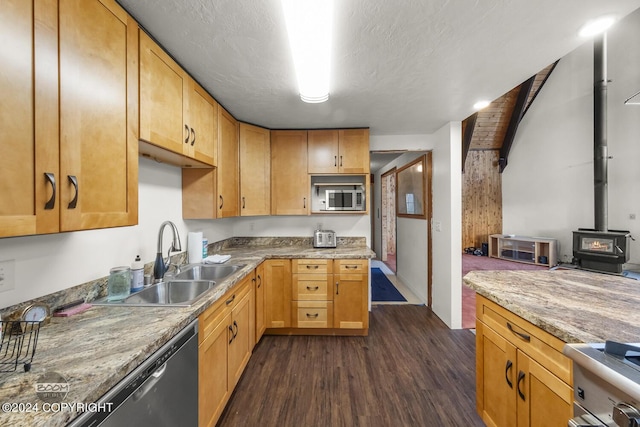 4480 E 138th Ave, Anchorage, AK 99516 - kitchen with stainless steel appliances, dark wood-type flooring, a sink, a wood stove, and light countertops