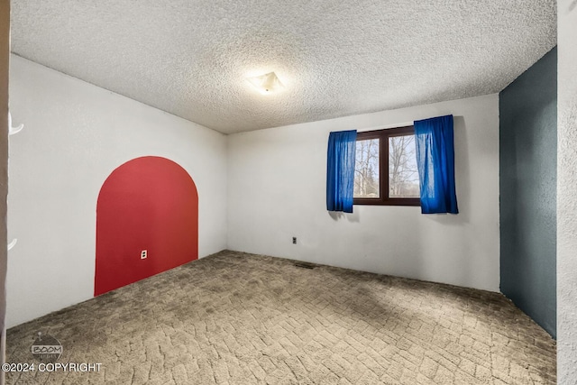 4480 E 138th Ave, Anchorage, AK 99516 - carpeted spare room featuring a textured ceiling