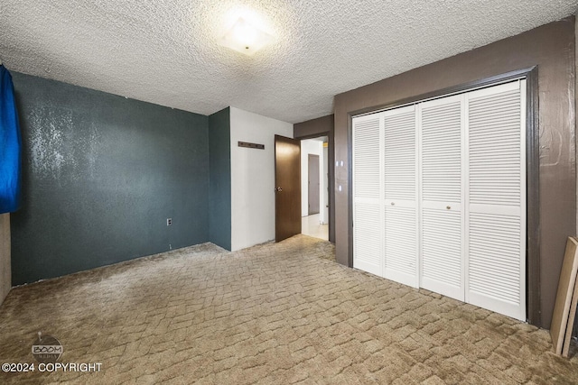 4480 E 138th Ave, Anchorage, AK 99516 - unfurnished bedroom featuring carpet flooring, a closet, and a textured ceiling