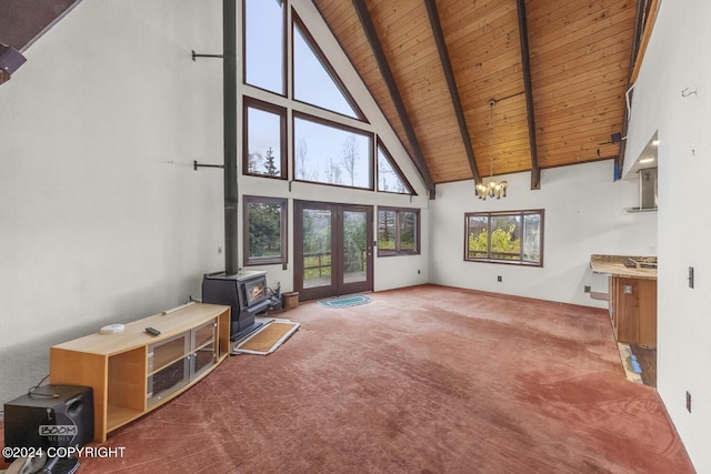 4480 E 138th Ave, Anchorage, AK 99516 - unfurnished living room with carpet, high vaulted ceiling, wooden ceiling with exposed beams, a chandelier, and a wood stove