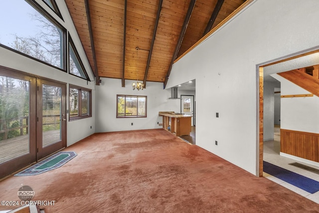 4480 E 138th Ave, Anchorage, AK 99516 - unfurnished living room with wood ceiling with exposed beams, high vaulted ceiling, a chandelier, carpet, and wainscoting