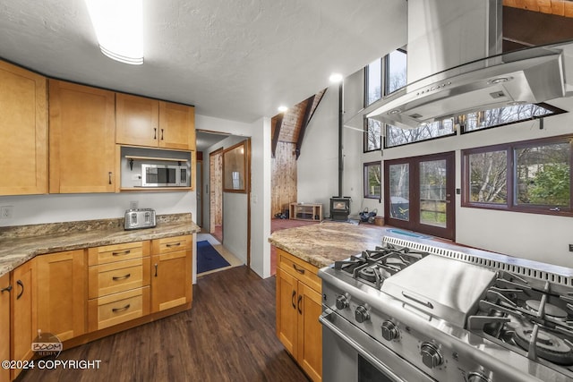 4480 E 138th Ave, Anchorage, AK 99516 - kitchen featuring appliances with stainless steel finishes, wall chimney exhaust hood, dark wood finished floors, light stone countertops, and a textured ceiling