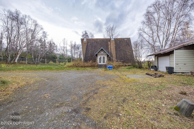 4480 E 138th Ave, Anchorage, AK 99516 - view of side of property with a chimney and french doors