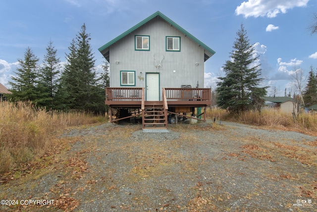 rear view of house with a wooden deck