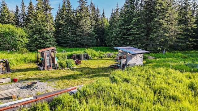 17597 Arcturus Loop, Ninilchik, AK 99639 - view of yard featuring a wooded view and an outbuilding