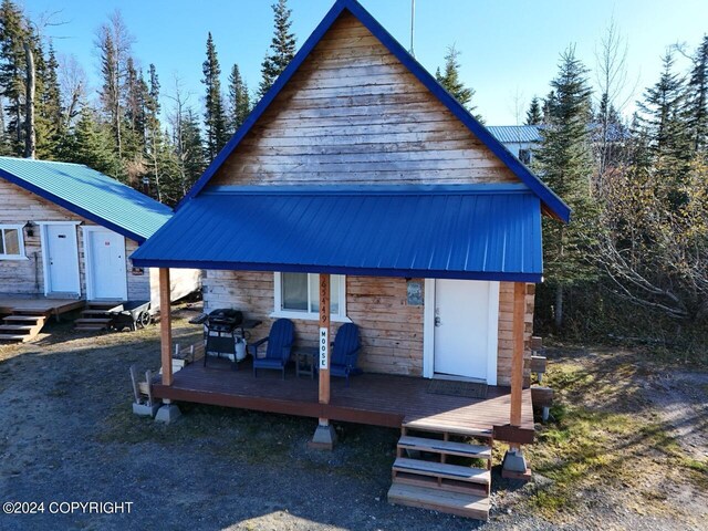 65449 Lingonberry Rd, Ninilchik, AK 99639 - view of front facade featuring an outdoor structure, metal roof, and a deck