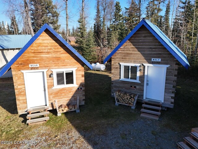 65449 Lingonberry Rd, Ninilchik, AK 99639 - back of property featuring an outdoor structure and entry steps