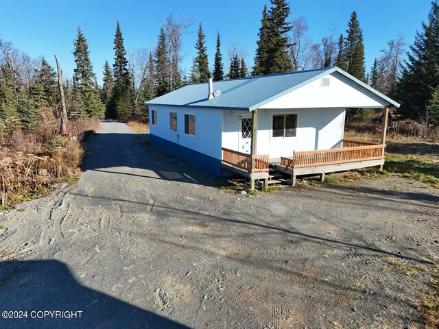 65449 Lingonberry Rd, Ninilchik, AK 99639 - view of front facade with metal roof and a deck