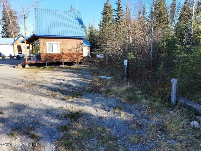 65449 Lingonberry Rd, Ninilchik, AK 99639 - view of side of property with a standing seam roof, a deck, and metal roof