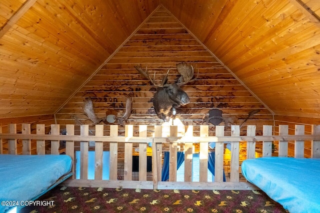 unfurnished bedroom with lofted ceiling, carpet flooring, and wood ceiling